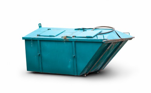 A large, industrial blue waste skip situated outdoors, likely on a driveway or warehouse yard, with a flat, rectangular shape and sturdy metal construction featuring vertical ribbing along the sides for reinforcement. The skip's surface displays a textured, semi-gloss finish, and its top edge is slightly raised with a smooth, reinforced lip. Two small lifting points are visible on the front left corner, and a black rubber hose or cable rests across the top, draping down the side. The rear of the skip has a sloped, openable tailgate or chute section, designed for easy loading of rubbish materials. The environment around the skip appears to be a clean, open space with no other objects or vehicles visible. This image provides a clear view of the skip's structure, materials, and functionality, relevant to rubbish removal services such as those offered by Commercial Waste Sidcup in the local Sidcup area postal code, compatible with services in the greater London borough.